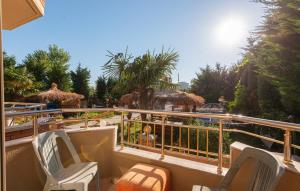 a balcony with chairs and a view of a resort at Serxhio Apartments in Golem