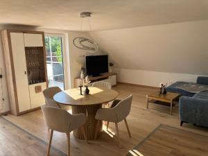 a living room with a table and chairs and a couch at Ferienwohnung Unterallgäu in Markt Rettenbach