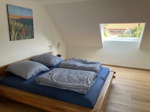 a bed with two pillows on it in a room at Ferienwohnung Unterallgäu in Markt Rettenbach