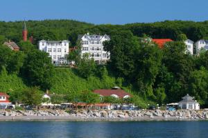 a group of buildings on a hill next to the water at Apartment Feodora in Sassnitz