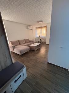 a living room with a couch and a table at M apartman in Paraćin