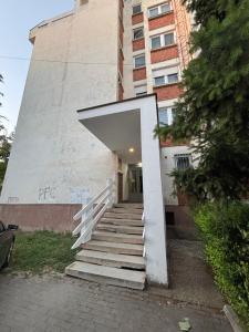 a stairway leading up to a building with a doorway at M apartman in Paraćin