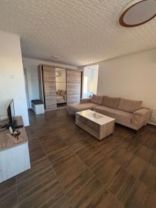 a living room with a couch and a coffee table at M apartman in Paraćin