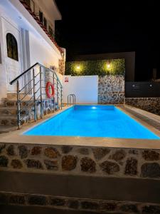 a swimming pool at night in a villa at Katsaras Sunset & Pool House in Kremasti