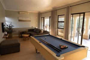 a living room with a pool table at Le Vaal Manor in Parys