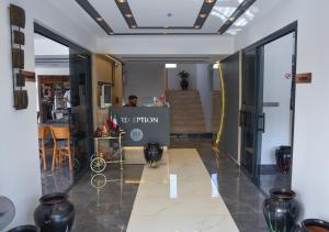 a man is standing in a room with a store at KENT HOTEL Didim in Didim