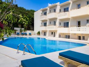 a swimming pool in front of a hotel at Agrimia Holiday Apartments in Platanias