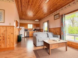 a living room with a couch and a table at Sundance Cottages in Cavendish
