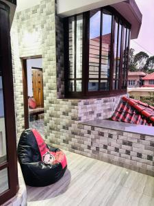 a house with a bean bag chair on the porch at Sai Srushti Homes in Gonikoppal