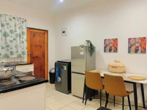 a kitchen with a refrigerator and a table and chairs at Asanta Guest House in Ladysmith