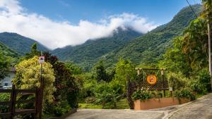 a road with a view of a mountain at Finca Ki' - Eco Farm Stay Bed & Breakfast - El Yunque Region in Naguabo