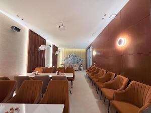 a restaurant with tables and chairs in a room at Radiance Hotel in Sirsa