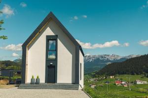 a small white chapel with mountains in the background at Serra Chalet in Fundata