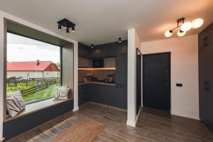 a kitchen with a large window and a large door at Serra Chalet in Fundata