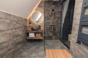 a bathroom with a shower with a glass shower stall at Serra Chalet in Fundata