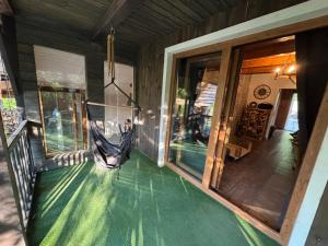 a hammock on the porch of a house at Rodzinne Zacisze in Radawa