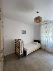 a white room with a bed and a window at Mateo Apartment in Himare