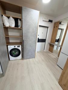 a laundry room with a washing machine and a washer at La Ion Residence 1 in Năvodari