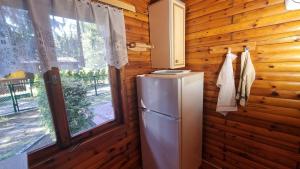 a refrigerator in a room with a window at Domek Szumin-Wywłoka in Majdan