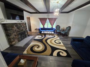 a living room with a blue couch and a fireplace at A J House in Plano