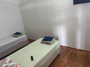 two beds in a room with white walls and wooden floors at POUSADA Br381 in Extrema +1 photo