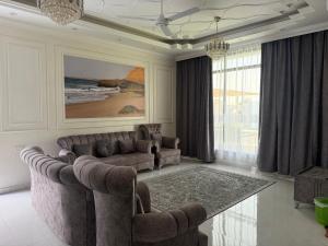 a living room with a couch and a table at Ras Al Hadd's bounty in Sur +3 photos
