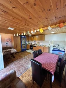 a kitchen and dining room with a table and chairs at Camping & Apartmens Scepanovic in Mojkovac