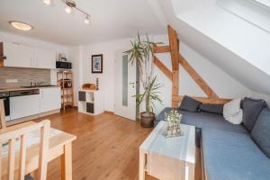 a living room with a blue couch and a table at Haus Auszeit in Rauris