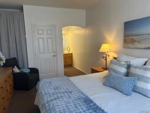 a hotel room with a bed and a chair and a room at The Cottage on the Coast in Oceano
