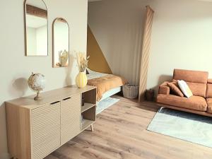 a bedroom with a bed and a dresser and a couch at Studio cosy Le3bis proche Cap d'Agde in Bessan