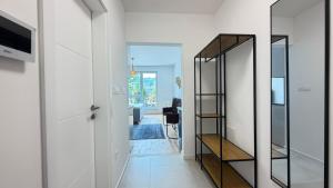 a hallway with a mirror next to a door at Salt Oasis Apartment Tuzla in Tuzla