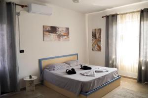 a bedroom with a bed with towels on it at Guest House by Roni in Durrës