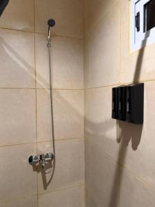 a shower with a shower head in a bathroom at Complejo San Carlos in General Acha +42 photos