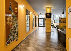 a hallway with yellow walls and a yellow wall at Gori Palace - Modern Apartments in City Centre in Gori