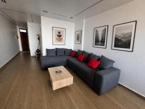 a living room with a couch and a coffee table at Belle appart in Aguemoun Taïda +1 photo