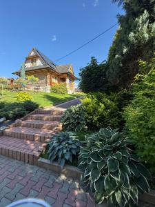 a house with a set of stairs in front of a yard at Domek Góralski U Hanki Domek przy Stoku in Małe Ciche