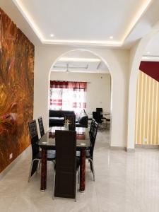 a dining room with a table and chairs at Peace apartment in Brufut