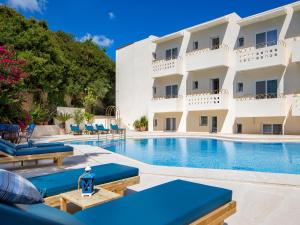 a swimming pool in front of a hotel at Agrimia Holiday Apartments in Platanias