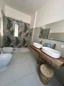 a bathroom with two sinks and two toilets at Mamma mia rooms in Nola +15 photos