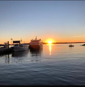 a group of boats docked at a dock with the sunset at Hvar-Zarace Ina 2 in Gdinj