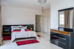 a bedroom with a bed and a dresser at Casa Borboleta in Arco da Calheta