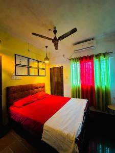 a bedroom with a bed with rainbow colored curtains at New Jtr Residency in Ernakulam
