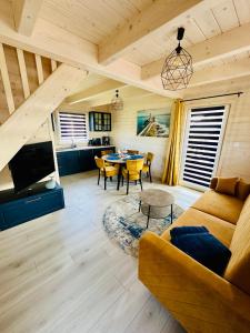 a living room with a couch and a table at Osada Mielenko in Mielenko