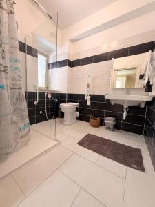 a bathroom with a shower and a toilet and a sink at Perla Marina B&B in Nicotera Marina