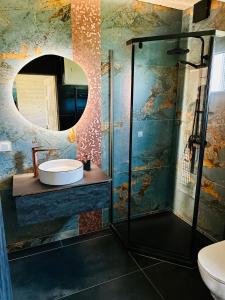 a bathroom with a sink and a shower with a mirror at Osada Mielenko in Mielenko +41 photos