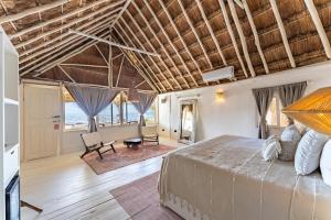 a bedroom with a large bed in a room at Hotel Qamar in Tulum