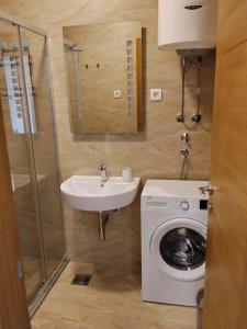 a bathroom with a sink and a washing machine at Apartman Vesna in Budva +12 photos