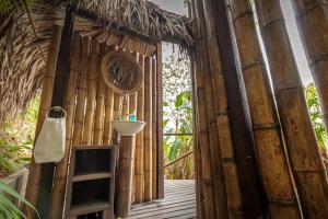 an entrance to a bamboo building with a ladder at EL bosque mica in Minca