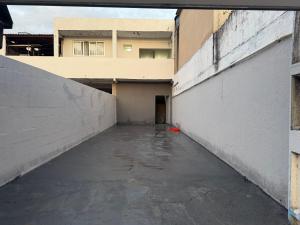 an empty alley in a building with water in it at Hostel do moreno in Vila Velha