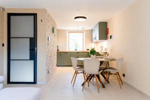 a kitchen and dining room with a table and chairs at L'aparté in Rochefort